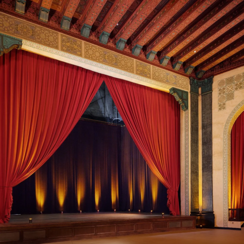 The Bonstelle theatre is adorned with crimson velvet curtains, a gilded ceiling, and other stunning architectural accents.